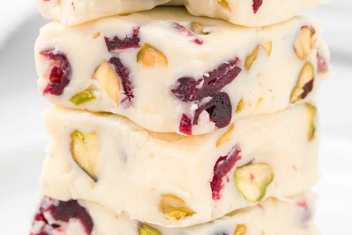 A cranberry and pistachio snack made from stacks of white chocolate fudge.