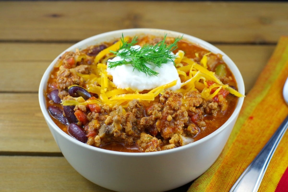 Chili in a bowl with sour cream.