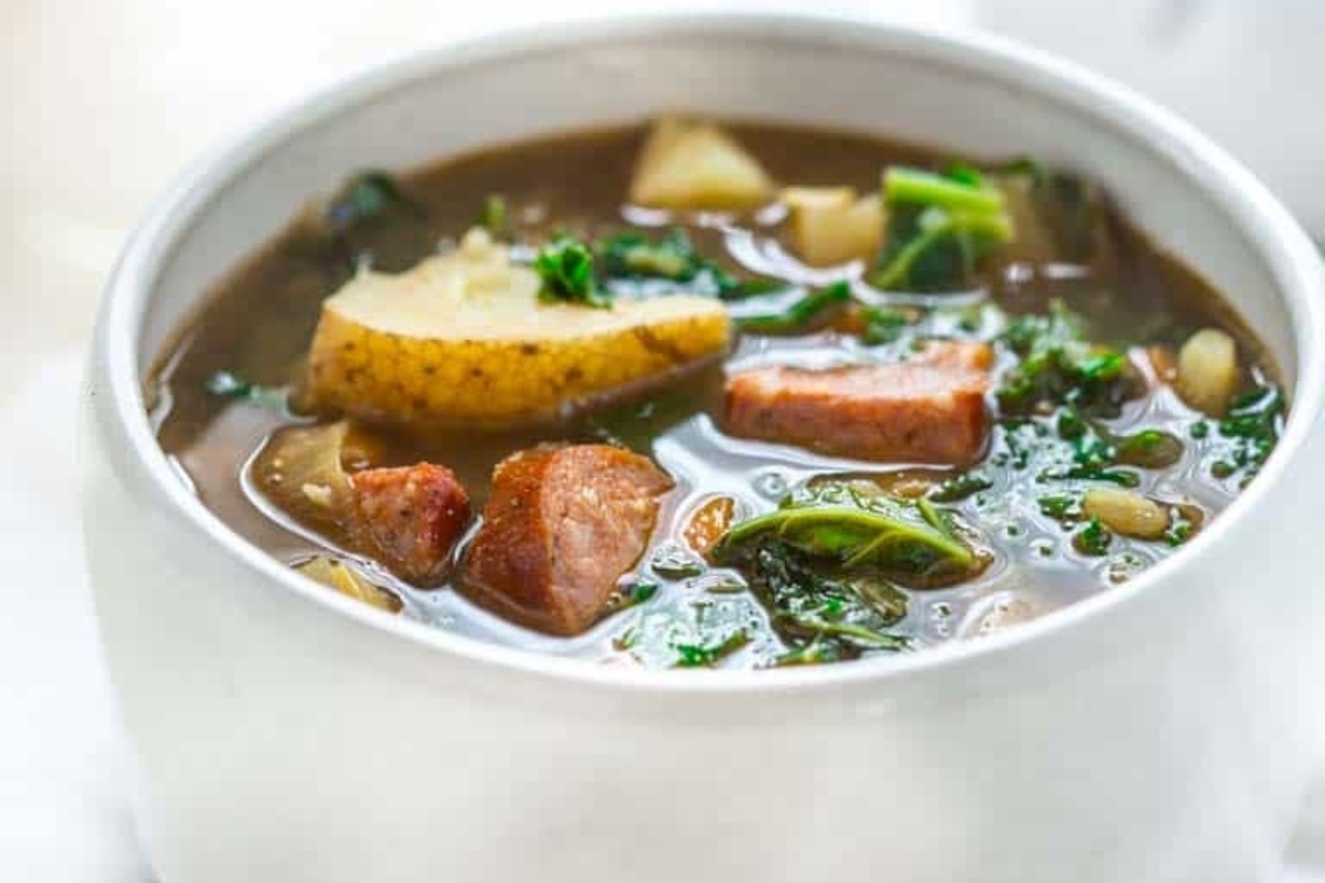 A hearty potato soup with sausage and greens.