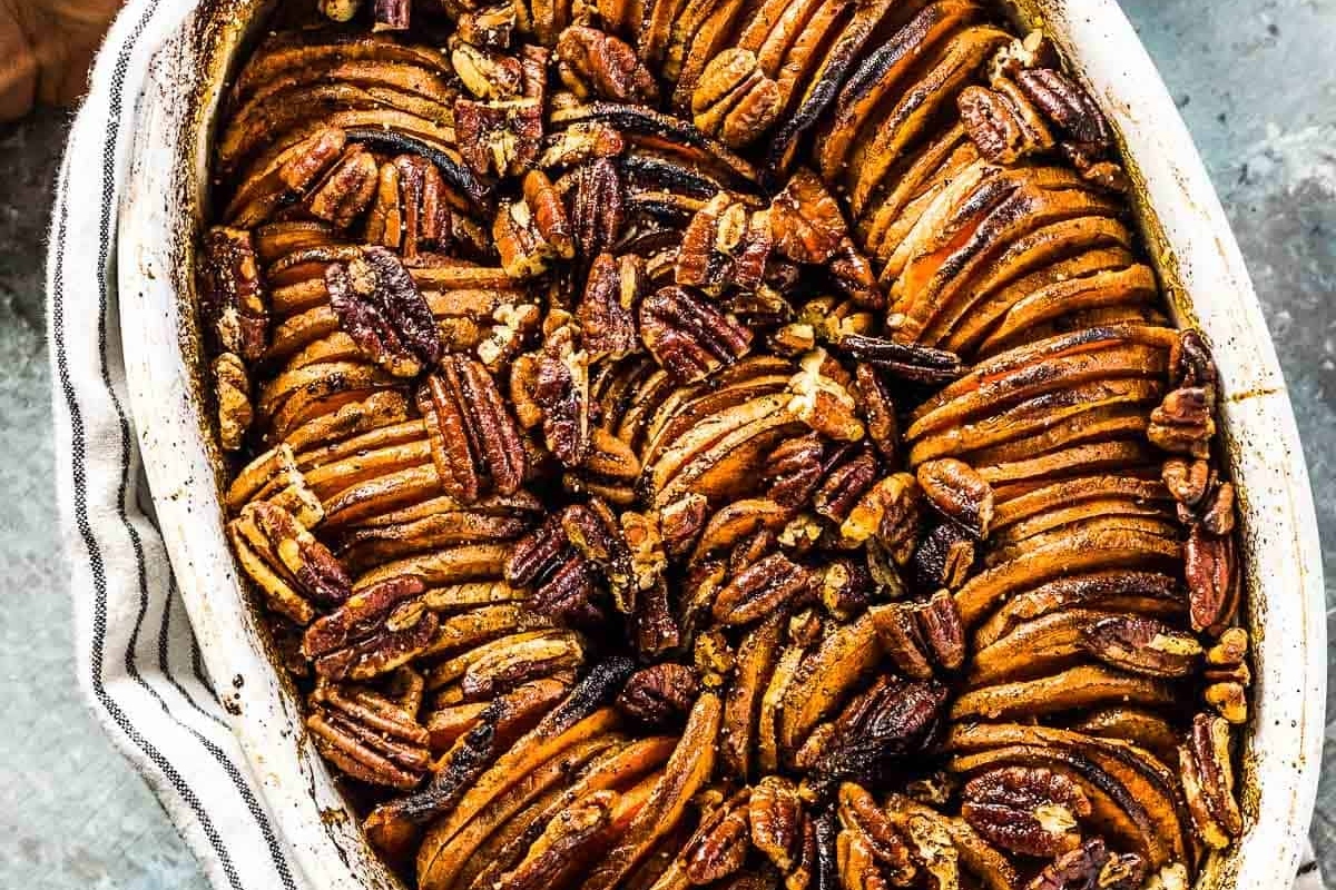 A thanksgiving baking dish filled with roasted pecans, perfect for make ahead recipes.