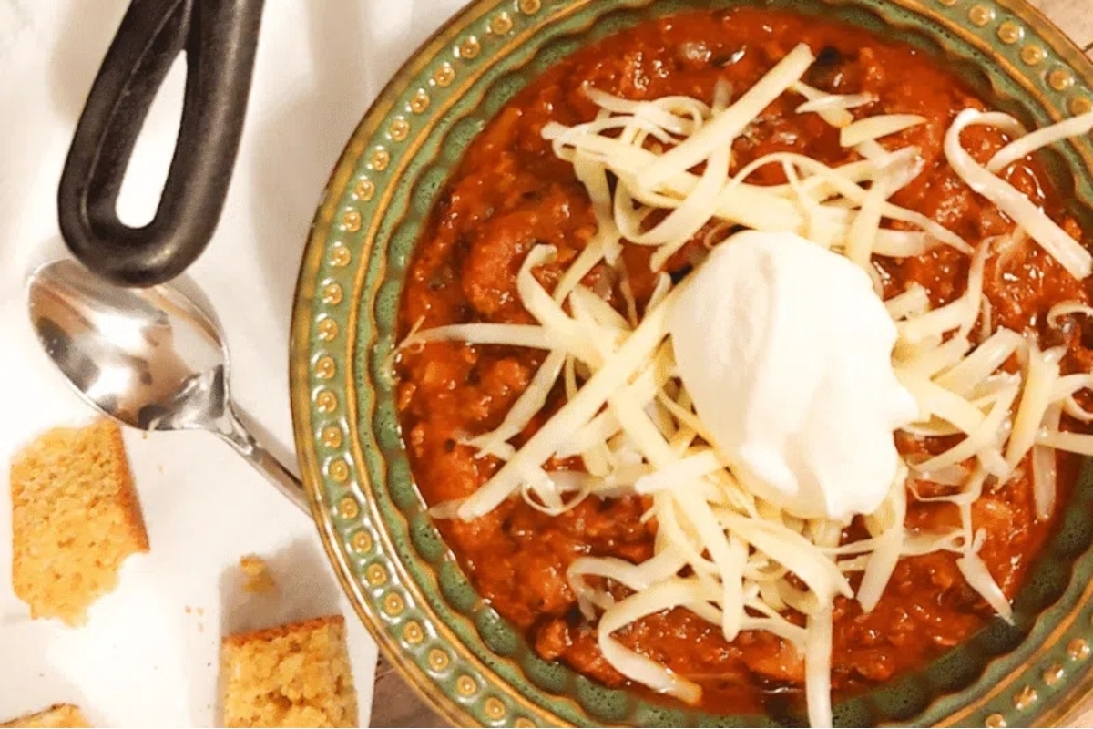 Explore delicious chili recipes garnished with cheese and sour cream.