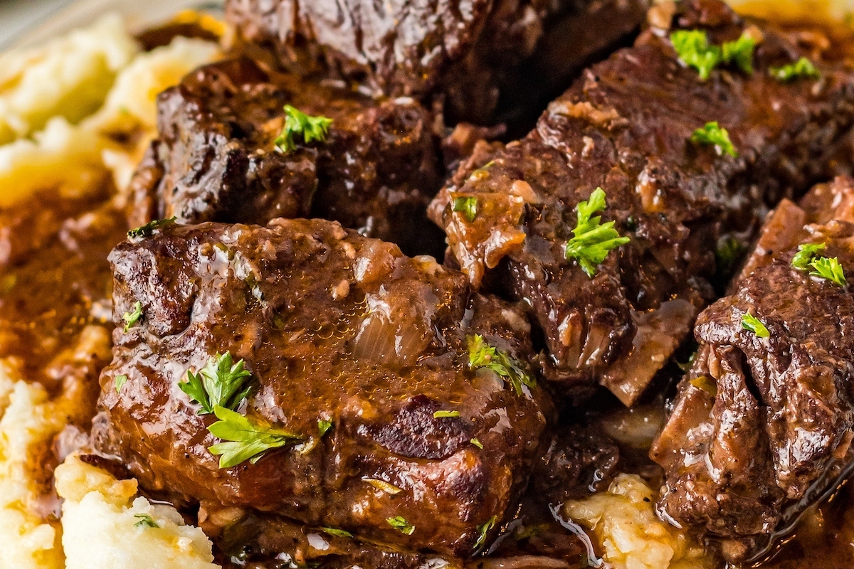 A Christmas dinner with beef and mashed potatoes smothered in gravy.
