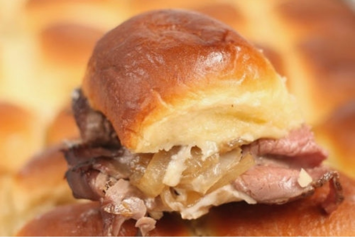 A Game Day favorite, this picture captures a scrumptious meat slider on a plate. The bite-sized delight is sure to satisfy any craving.