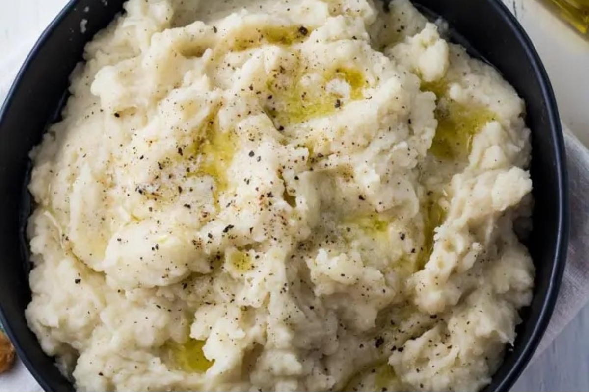 A bowl of mashed potatoes with truffle oil.