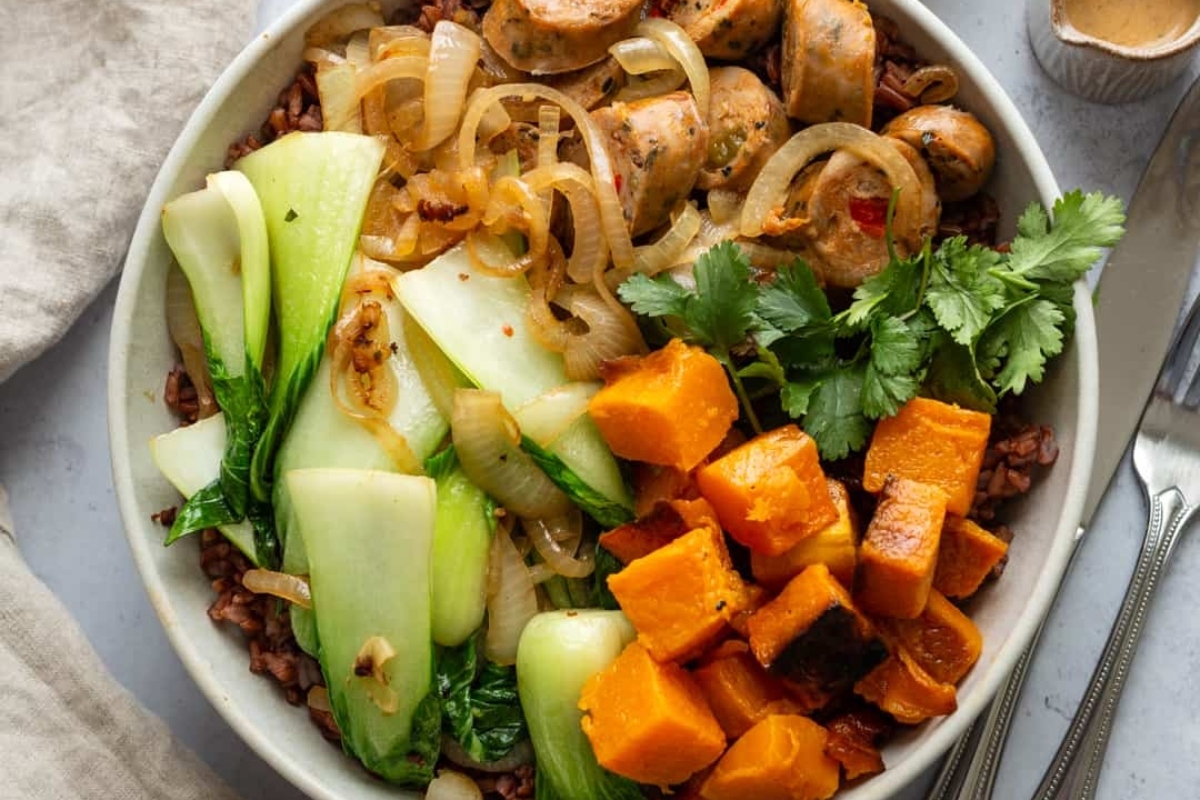A grain bowl of asian stir-fry with mushrooms, onions and sweet potatoes.