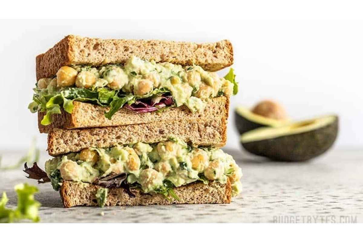 A stack of healthy sandwiches packed with avocado and chickpeas, perfect for high protein lunches.