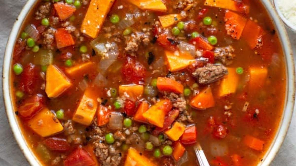 A shared bowl of comfort food stew, rounded up with meat, vegetables and peas.