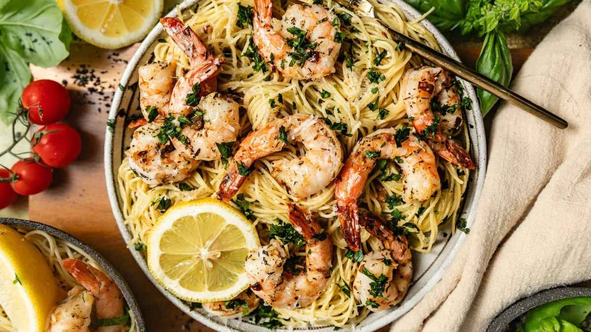 Shrimp scampi with lemon on the side.