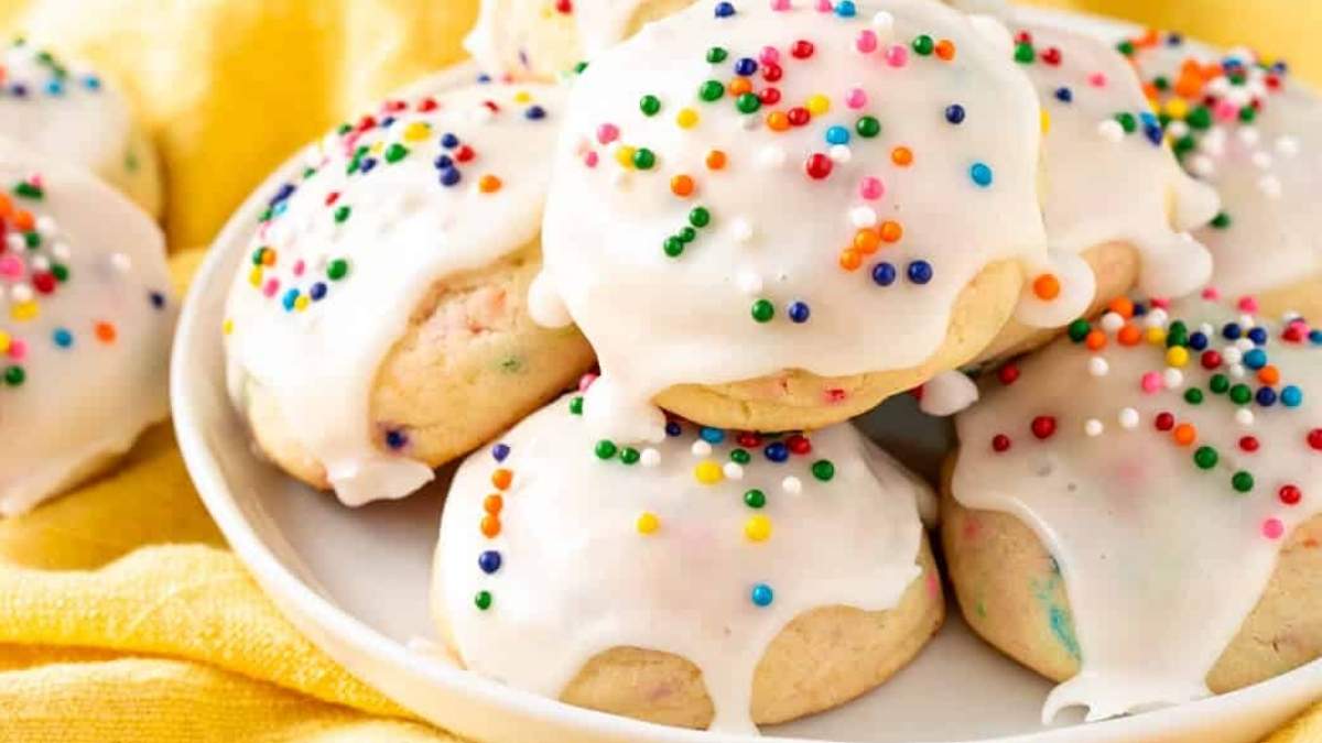 A plate of cookies with sprinkles and icing, perfect for a festive treat.