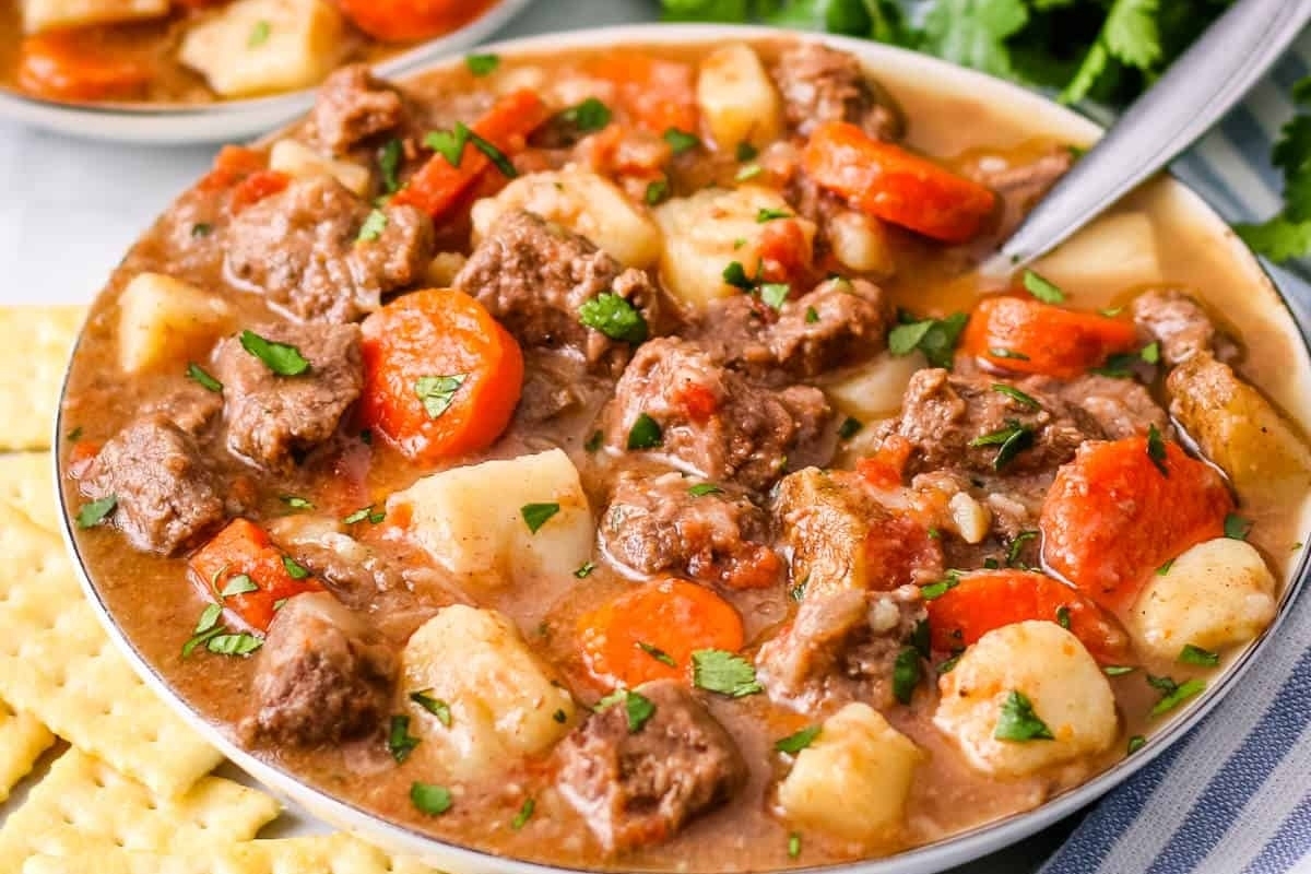 A slow cooker stew with tender beef, potatoes, and carrots.