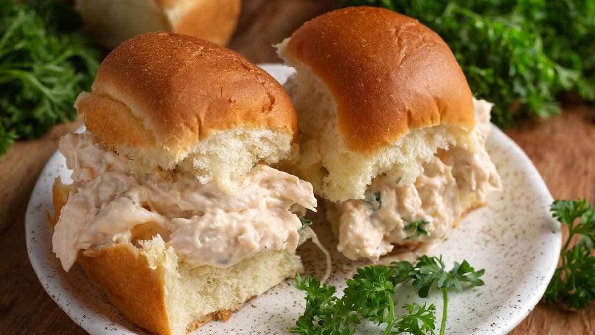 Slow Cooker Chicken sliders on a plate with parsley.