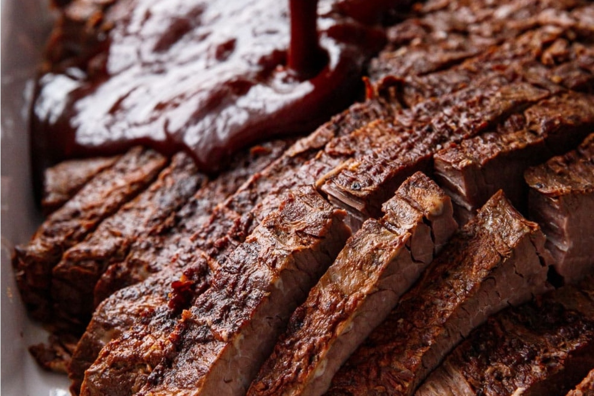 Christmas dinner featuring barbecue beef ribs with smoky bbq sauce, elegantly presented on a white plate.