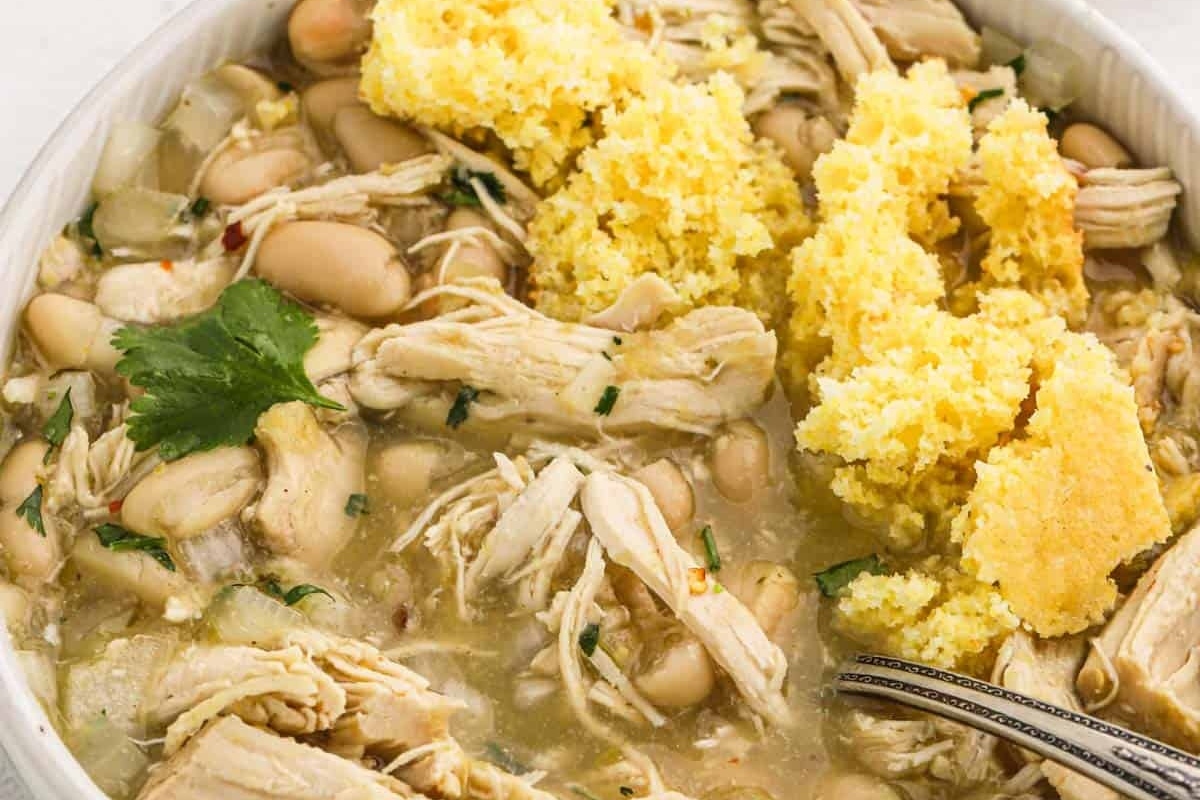 Chicken and white bean chili served in a white bowl.