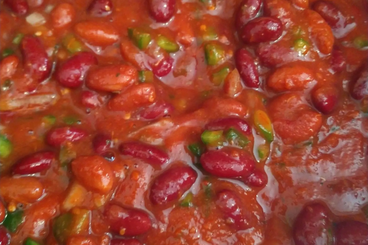 A close up of red beans in a chili sauce.