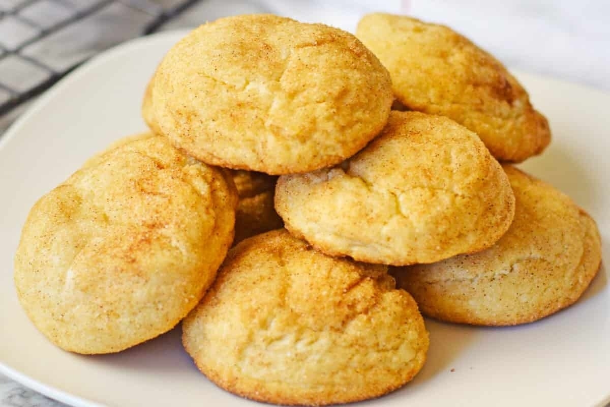 A stack of Christmas cookies on a white plate.