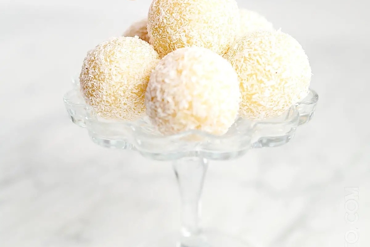 Festive Christmas Coconut Balls on a Glass Plate.