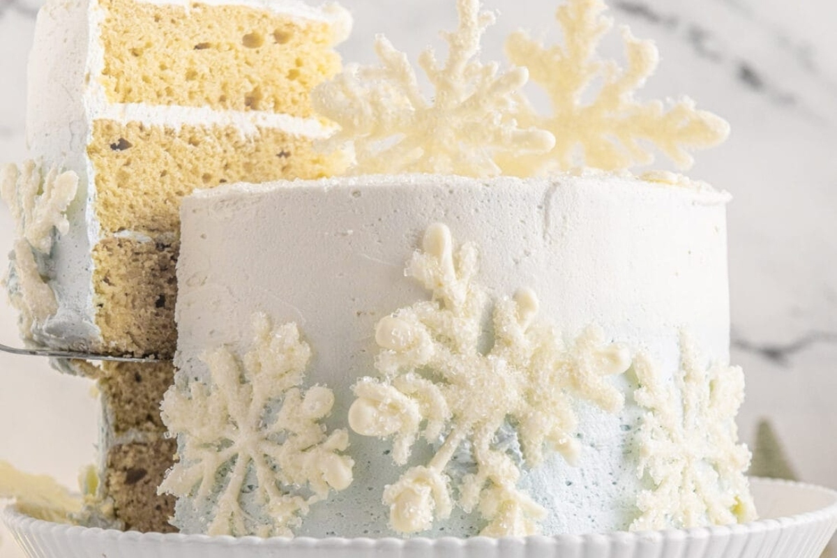 A white cake with snowflakes on top.