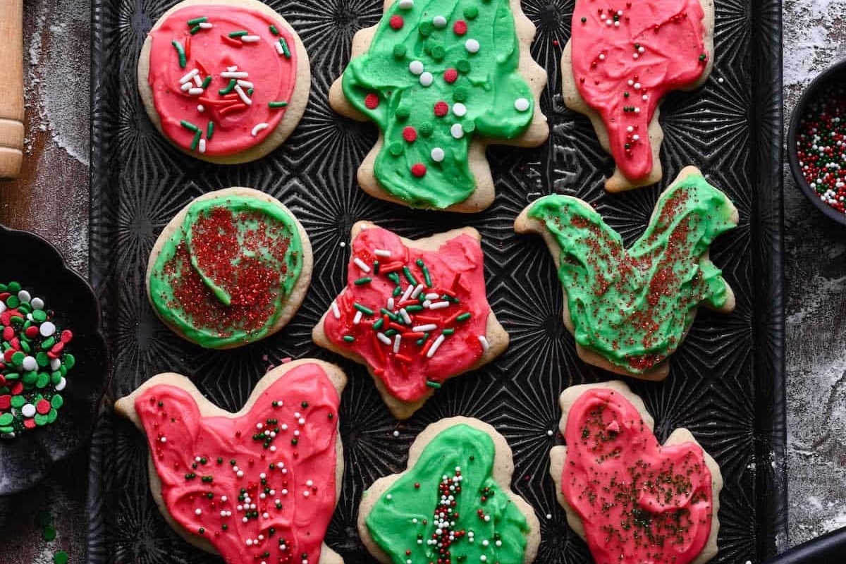 Christmas cut out sugar cookies on a baking sheet.