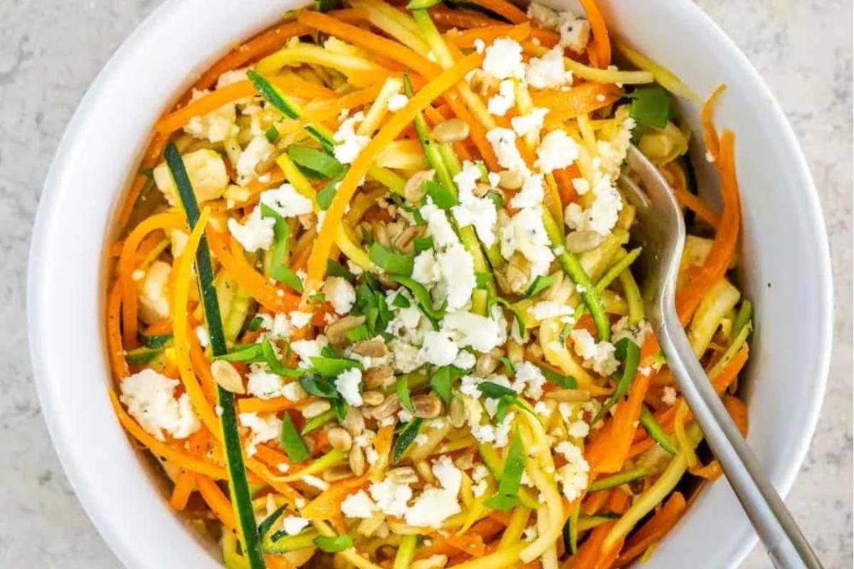 A delicious bowl of spiralized zucchini noodles with feta and kalamata olives, perfect for a healthy meal.