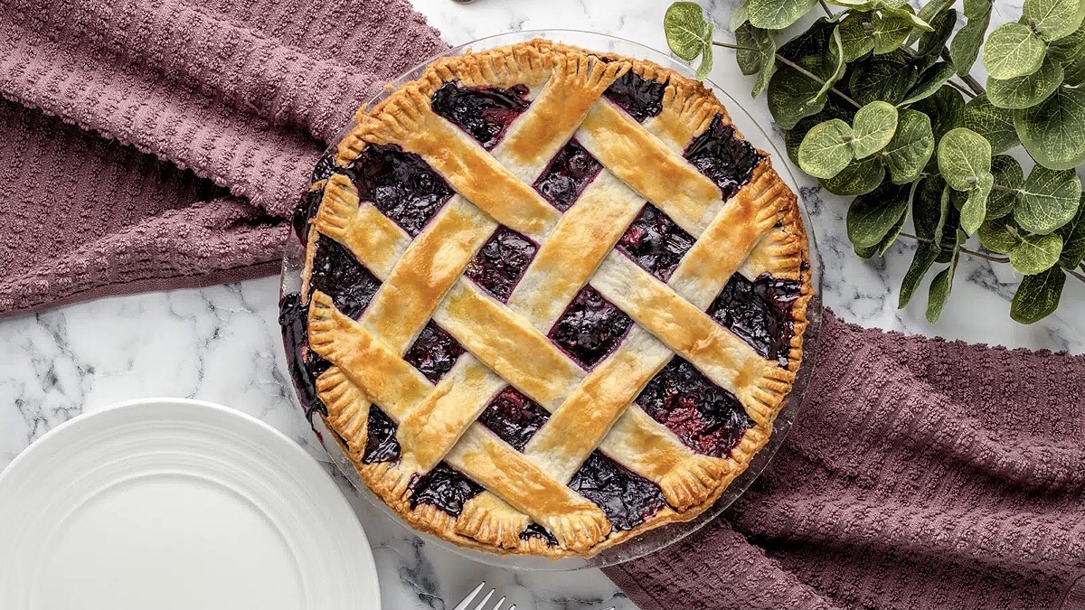 A sweet strawberry blueberry pie with a lattice pattern on top.