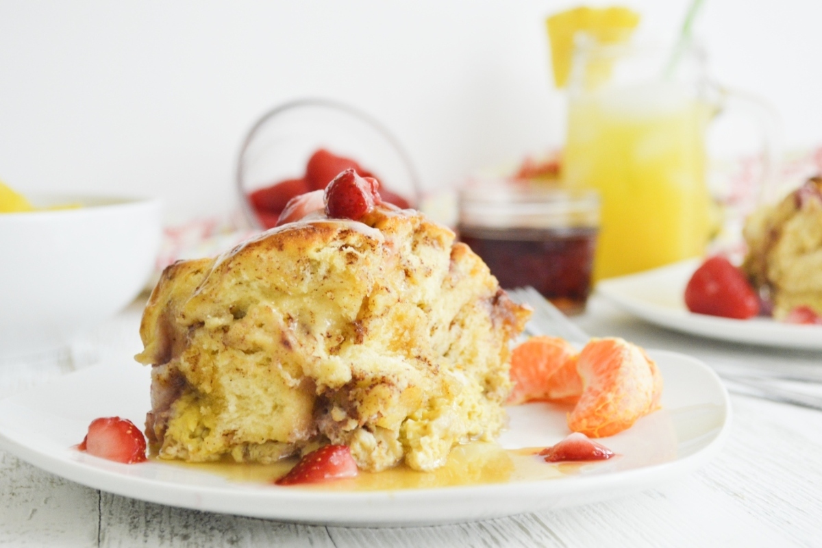 A sweet breakfast with a plate of French toast and a cup of orange juice.