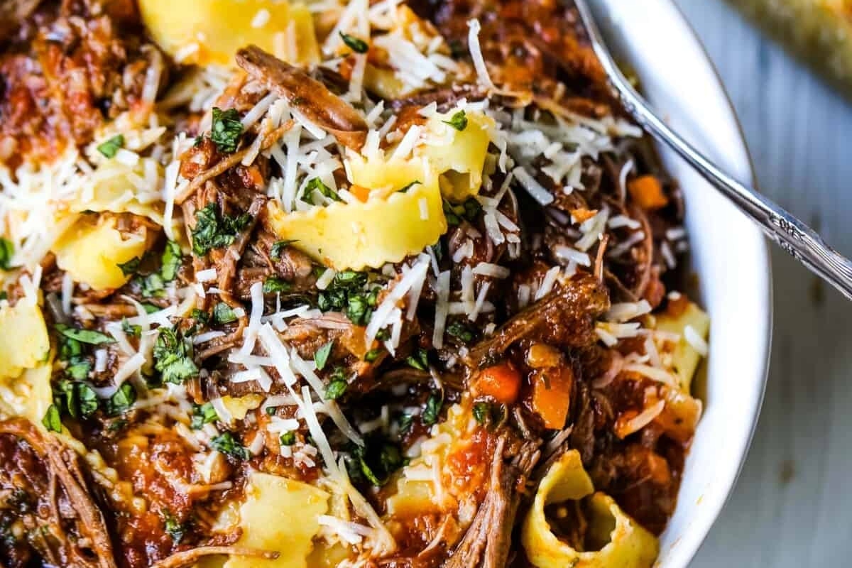 A winter recipe featuring a white bowl filled with pasta and beef.