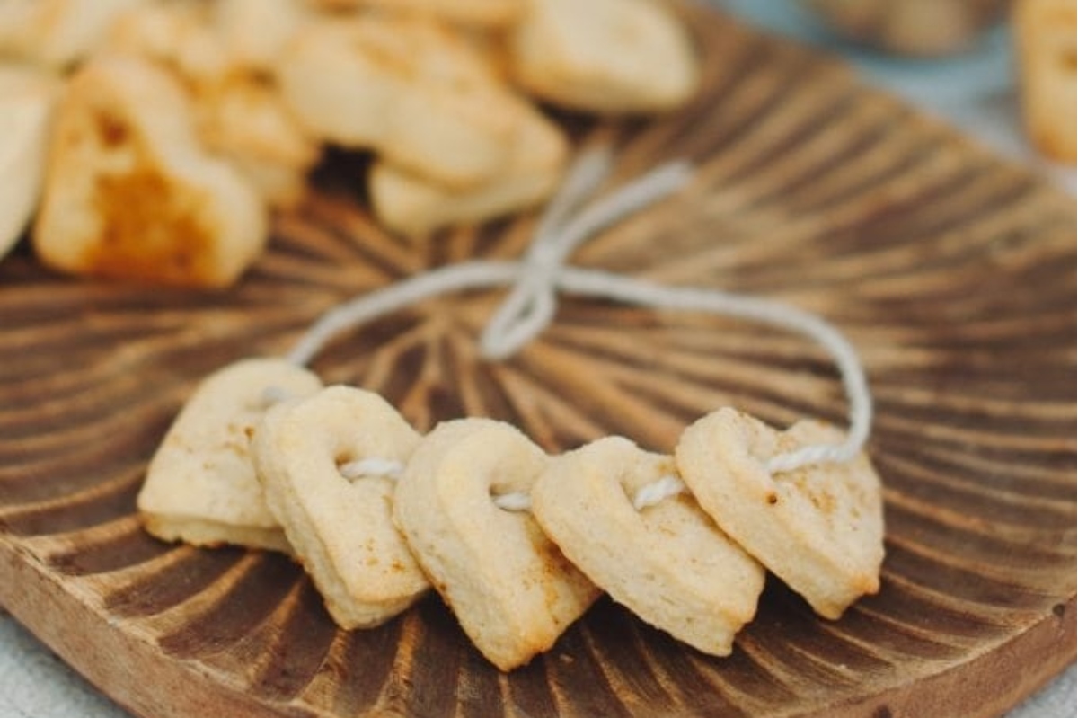 Heart shaped cookies on a wooden cutting board.