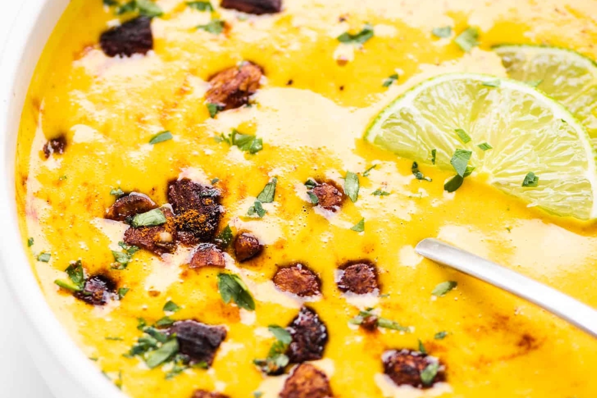 A bowl of guacamole with lime and bacon, perfect for delicious appetizers or as a unique twist to traditional recipes.
