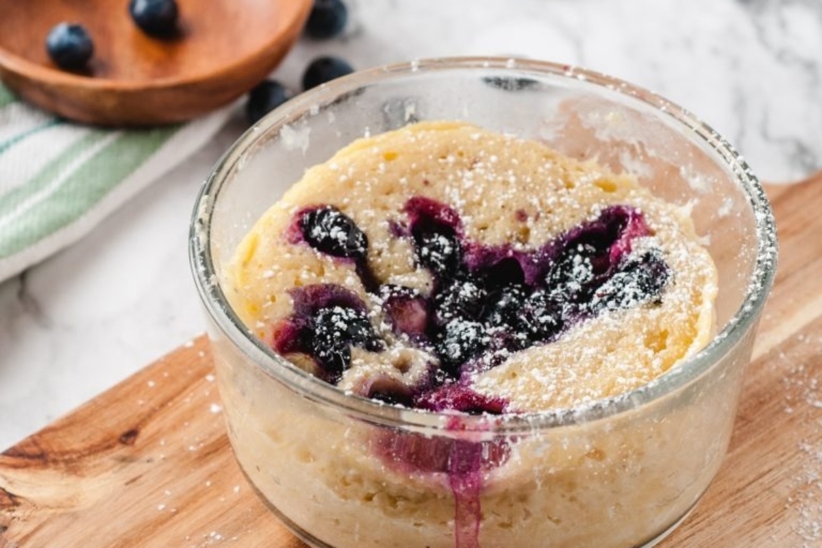 Blueberry pancakes recipes in a glass on a cutting board.