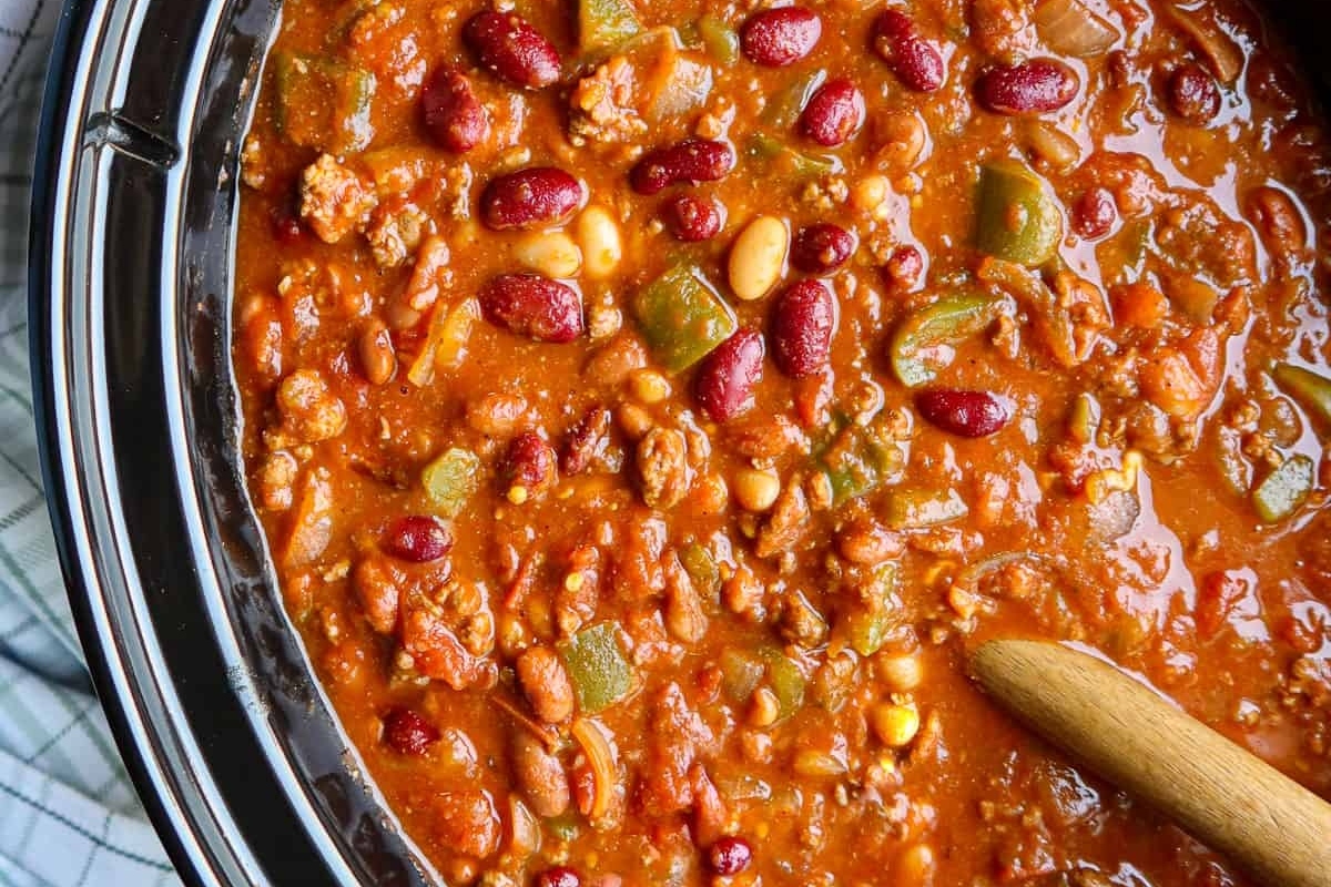 Chili Recipes made easy with a slow cooker and a wooden spoon.