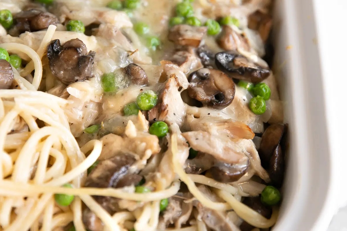 A make-ahead casserole dish filled with pasta, mushrooms and peas perfect for Thanksgiving.