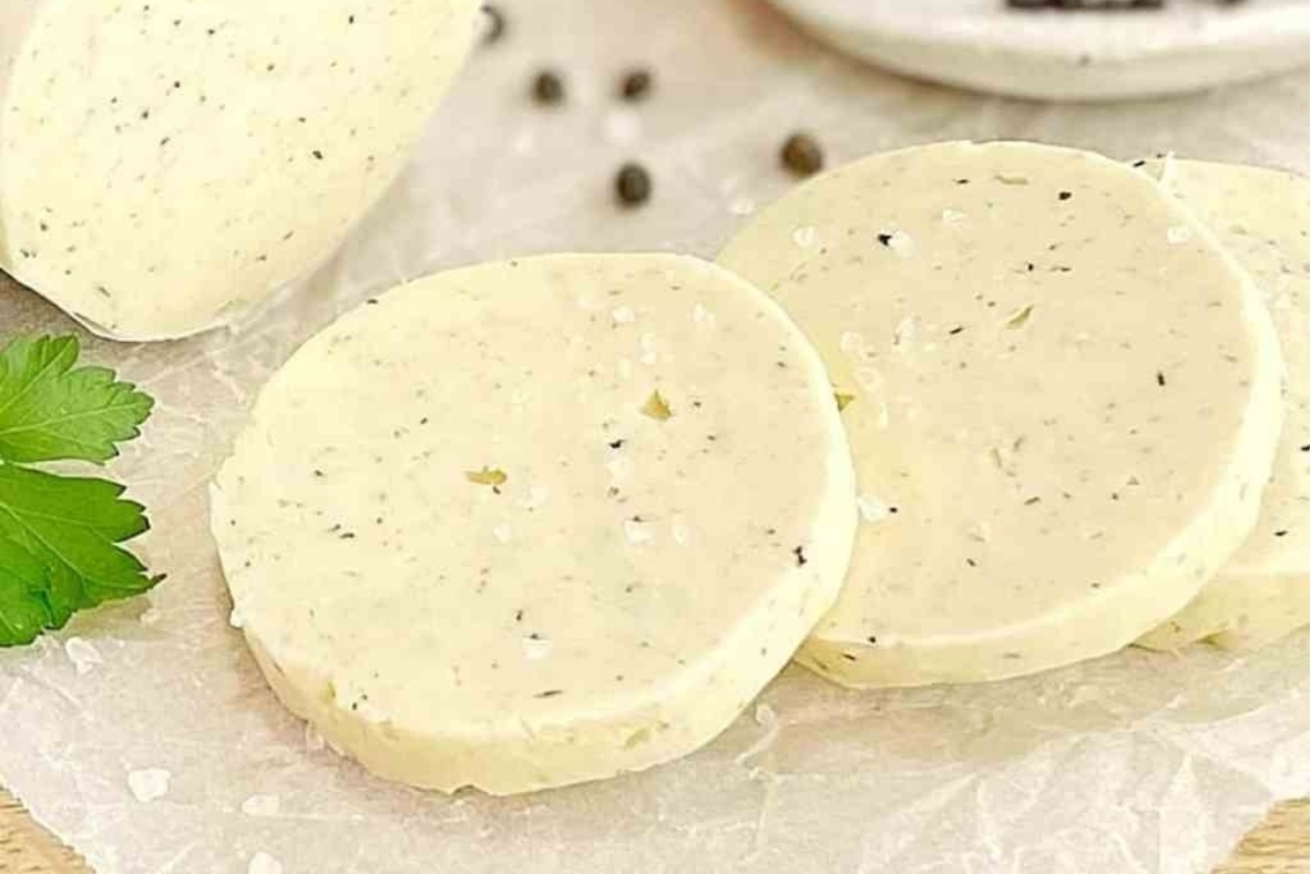 Three slices of cheese on top of a piece of paper, perfect for truffle oil-infused recipes.