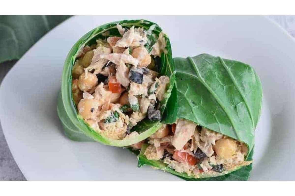 A healthy high protein lunch option, featuring a plate with a wrap filled with chicken and vegetables.