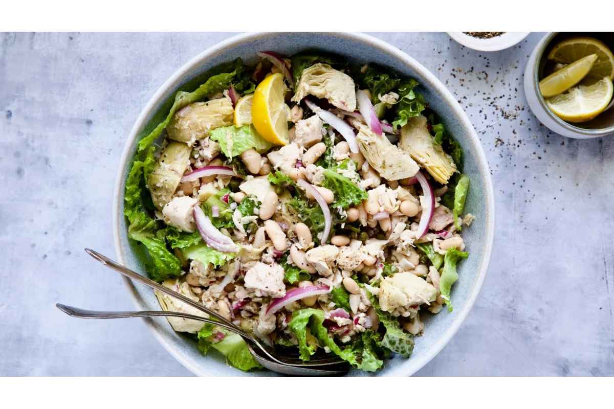 A high-protein salad with lemon wedges.