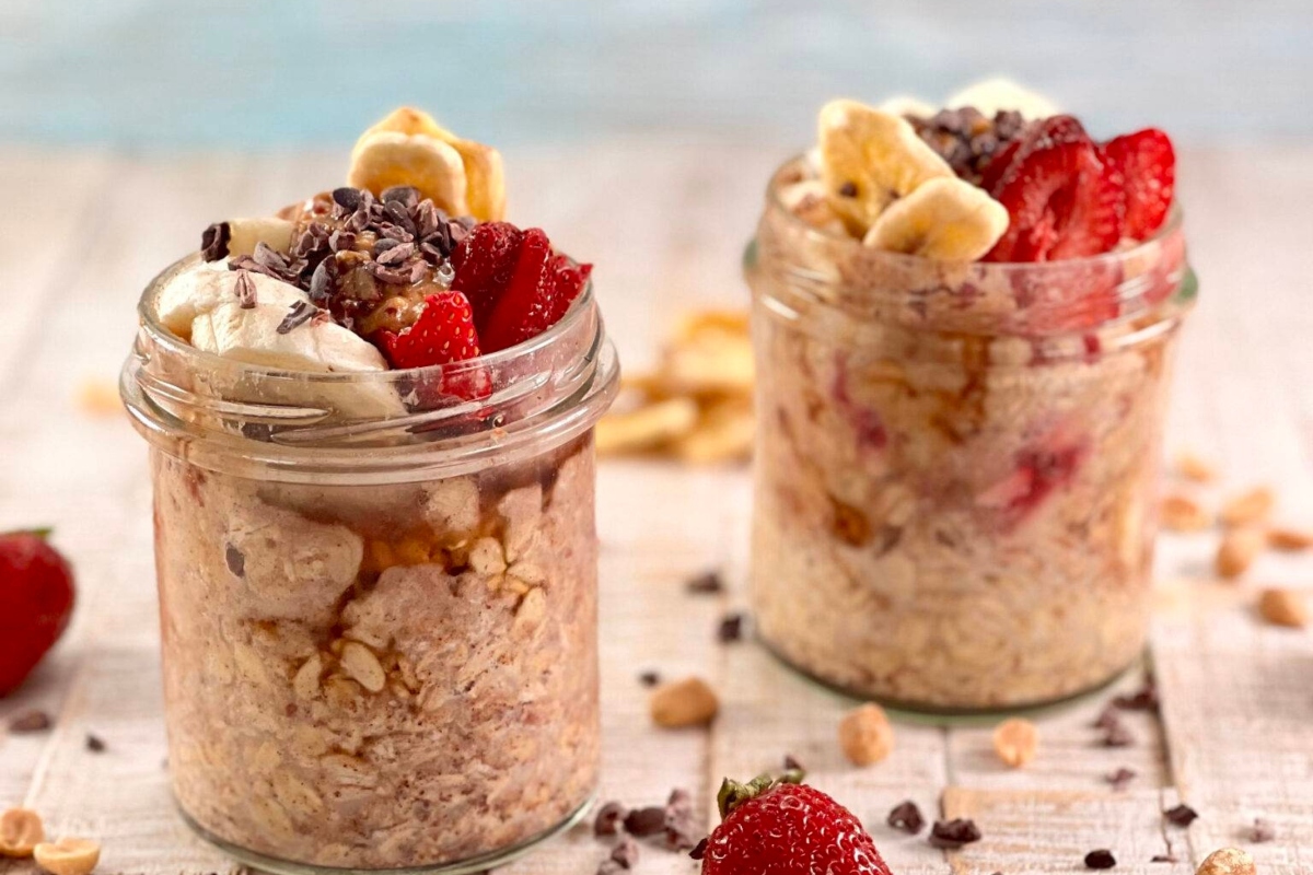 Two jars of healthy oatmeal with strawberries and bananas.