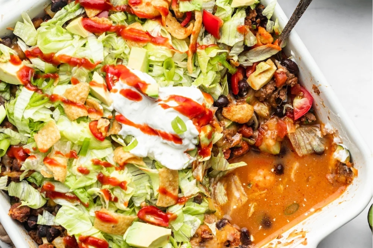Mexican casserole topped with sour cream - perfect for Taco Night!