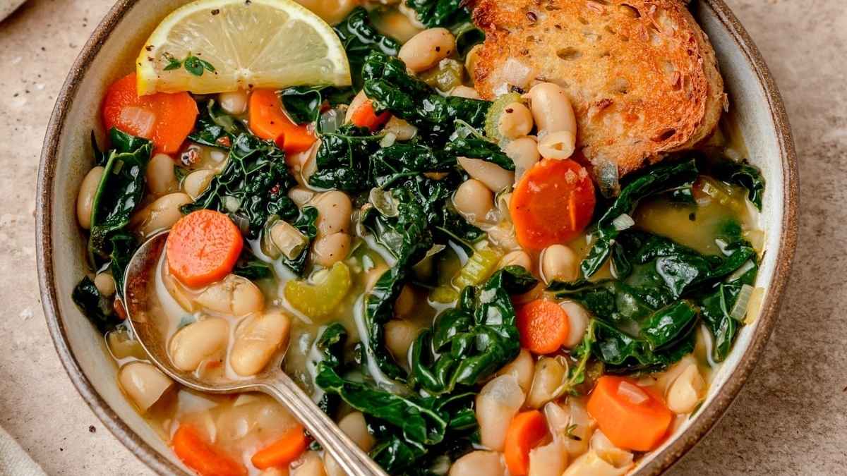 White bean and kale soup in a bowl.