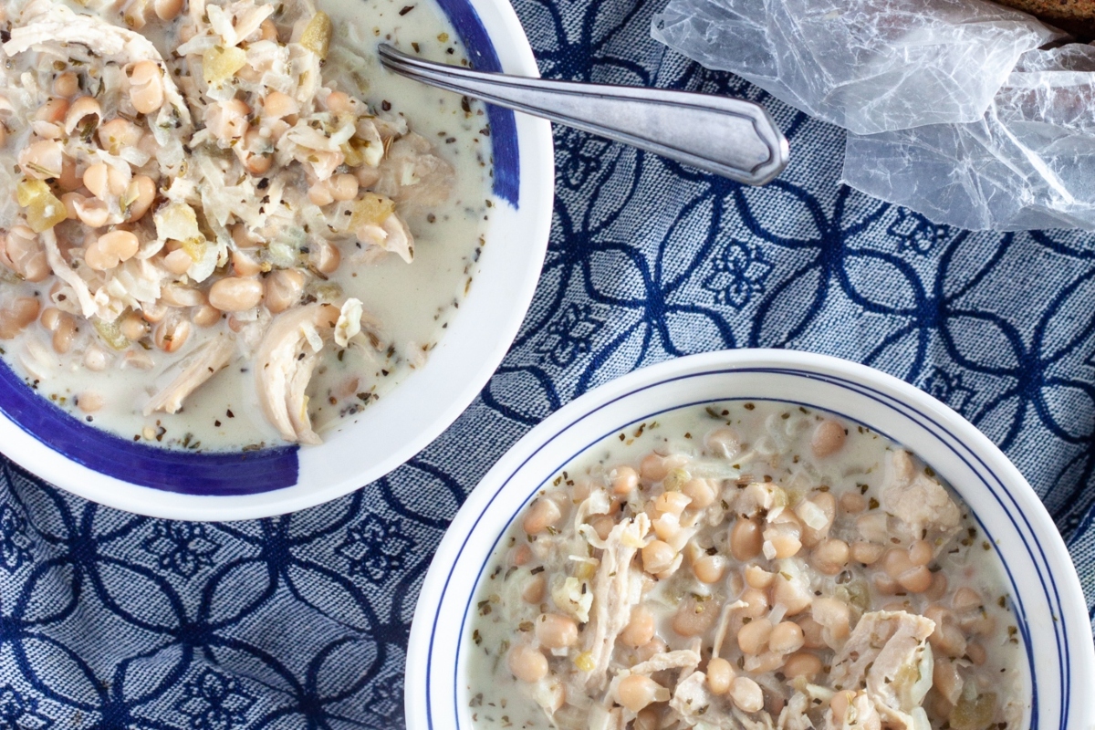 Two bowls of chicken and chickpea soup on a table, perfect for those looking for delicious chili recipes.