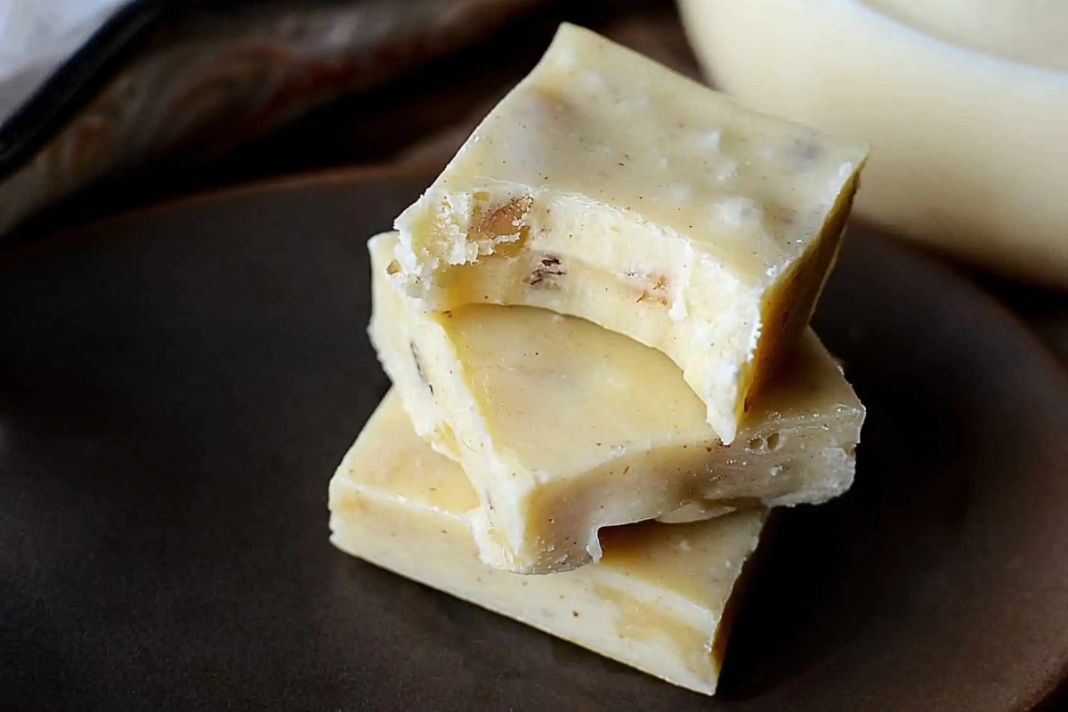 Three pieces of Christmas fudge stacked on top of each other.