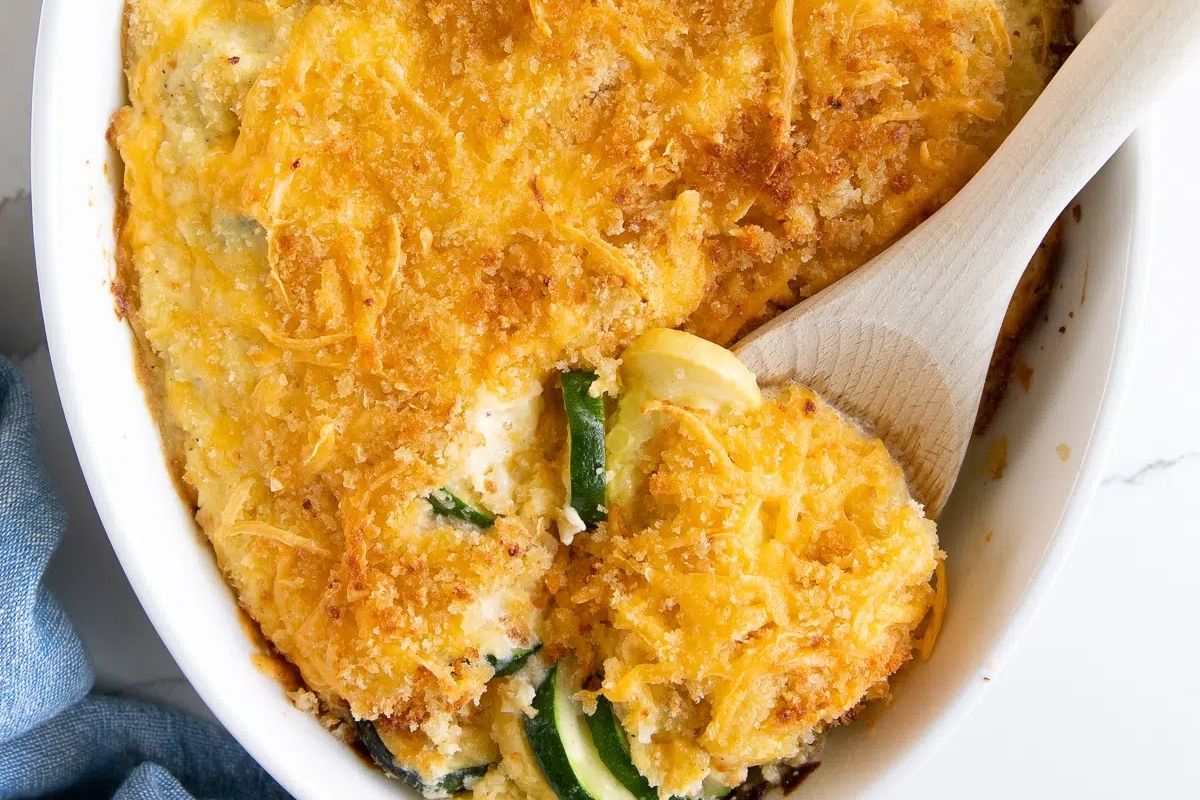 A make-ahead Thanksgiving casserole dish with a wooden spoon in it.
