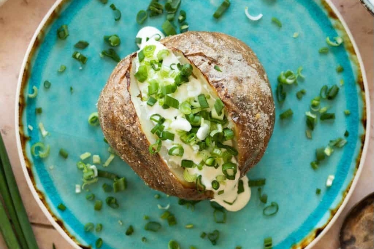 A Game Day favorite, this recipe features a delicious baked potato topped with tangy sour cream and fresh green onions.