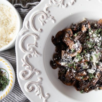 A plate with air fryer mushrooms and parmesan on it.