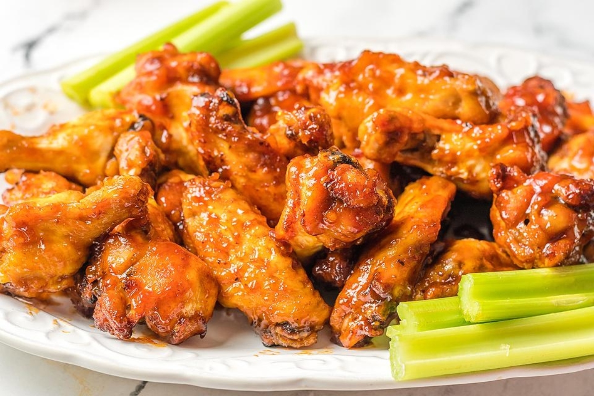 Game day recipe featuring chicken wings served on a plate with celery and celery sticks.