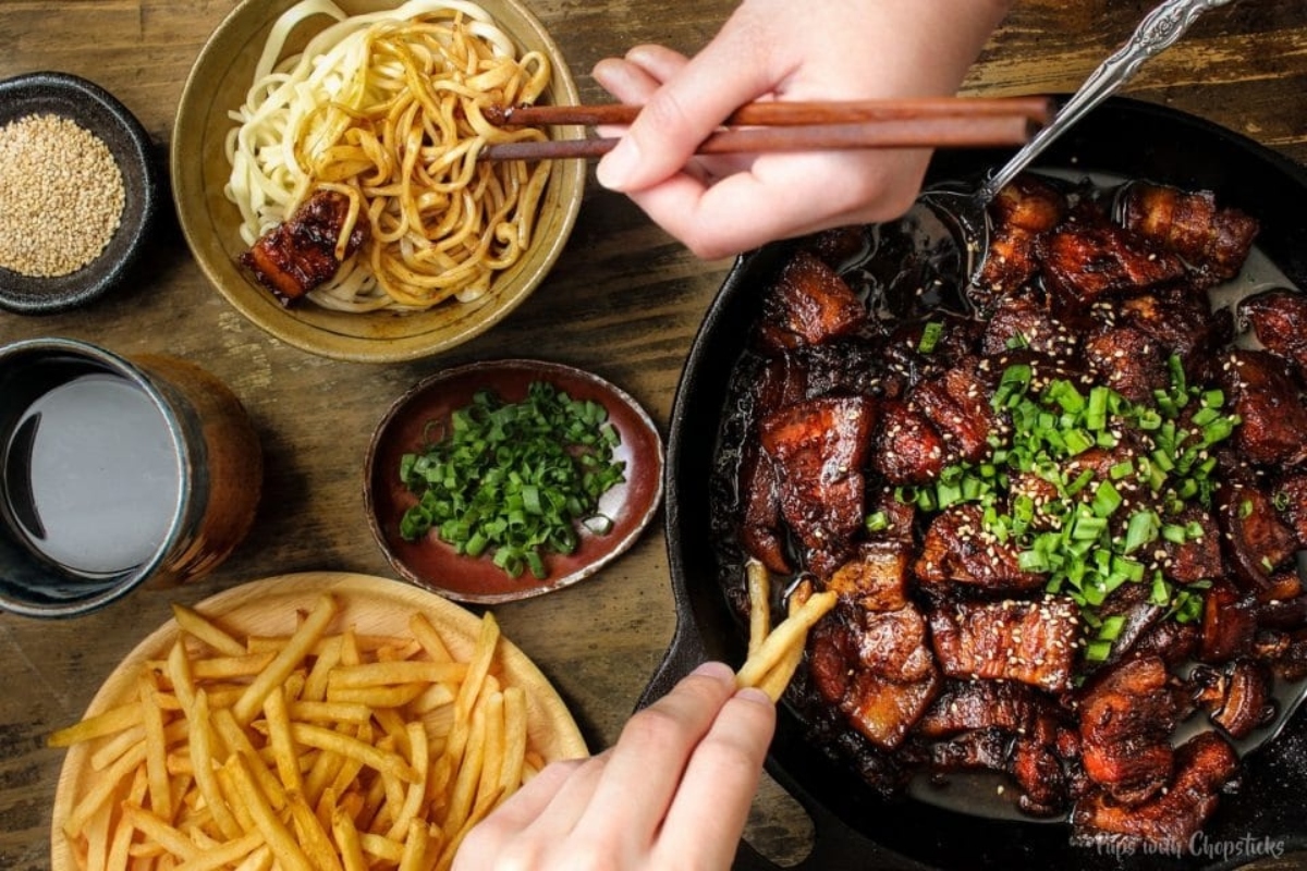 Chinese fried rice with pork and fries, perfect for a winter dinner, served on a wooden table.