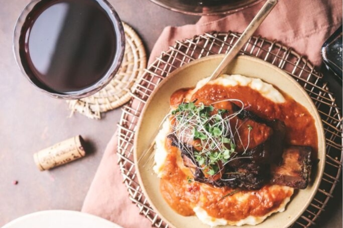 A plate of mashed potatoes and a glass of red wine, perfect for cozy winter nights.