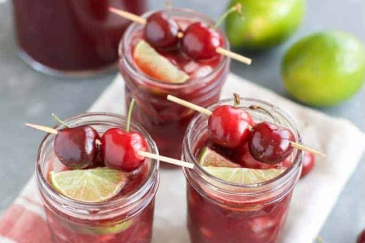 Valentine's Day cocktails: Cherry sangria in mason jars with limes and cherries.