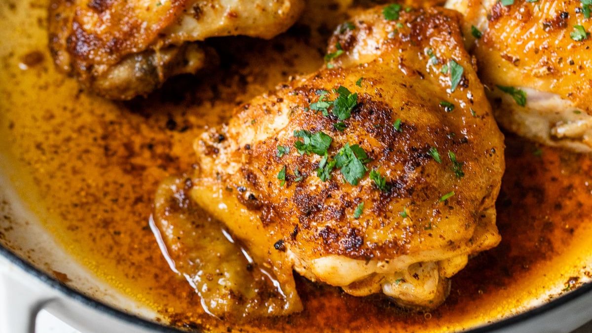 chicken thighs in pan with herbs