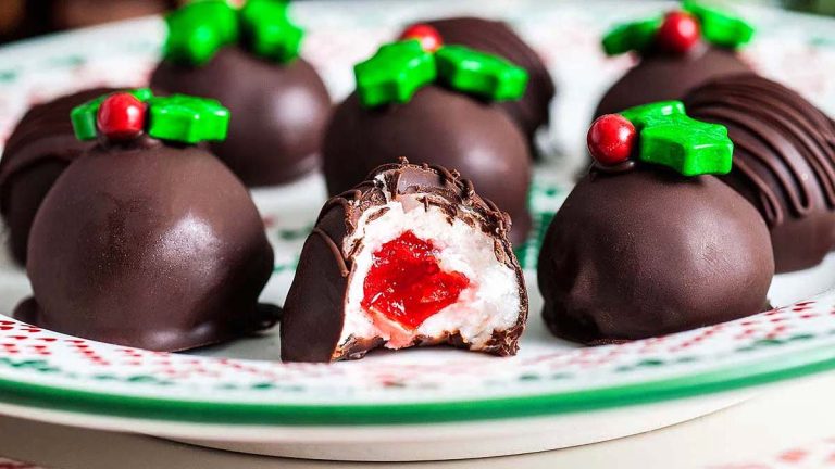 Delicious chocolate holly balls decorated with holly leaves, perfect for your Christmas candy recipes!