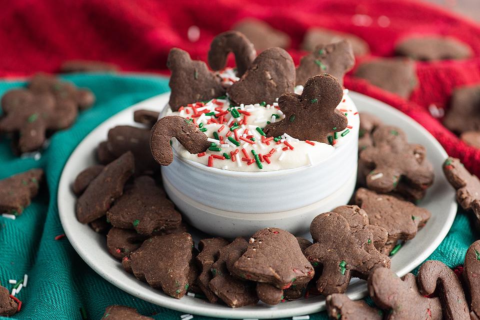 Freezable chocolate gingerbread cookies on a plate with whipped cream and sprinkles, perfect for Christmas.