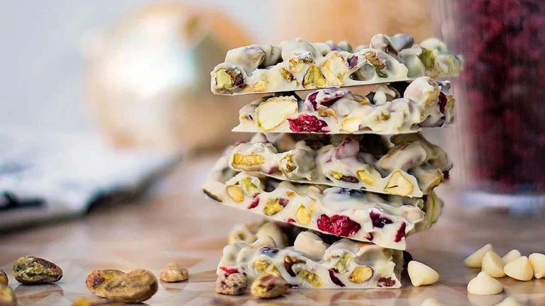 A stack of white chocolate and pistachio bars on a table, perfect for indulging in delicious pistachio recipes.